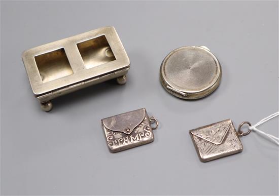 A silver double stamp box, two silver envelope stamp cases and a pill box.